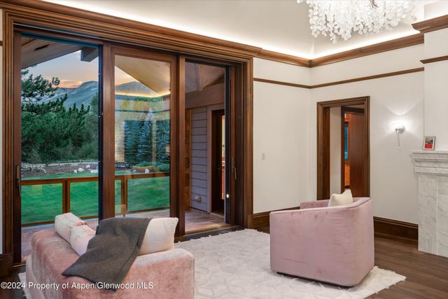 a large white kitchen with kitchen island granite countertop a stove and a sink