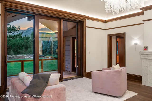 a large white kitchen with kitchen island granite countertop a stove and a sink