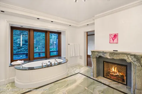 a view of a bathroom with a tub and shower