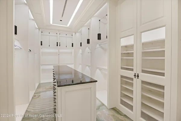 a living room with granite countertop furniture and flat screen tv
