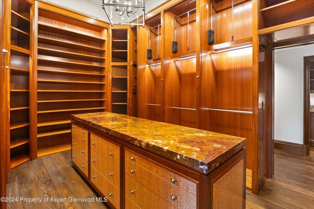 a bedroom with furniture and a large window