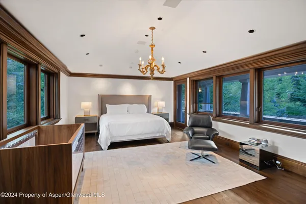 a bedroom with a large bed and a large window