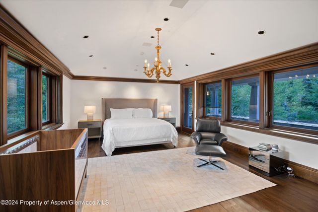 a bedroom with a large bed and a large window