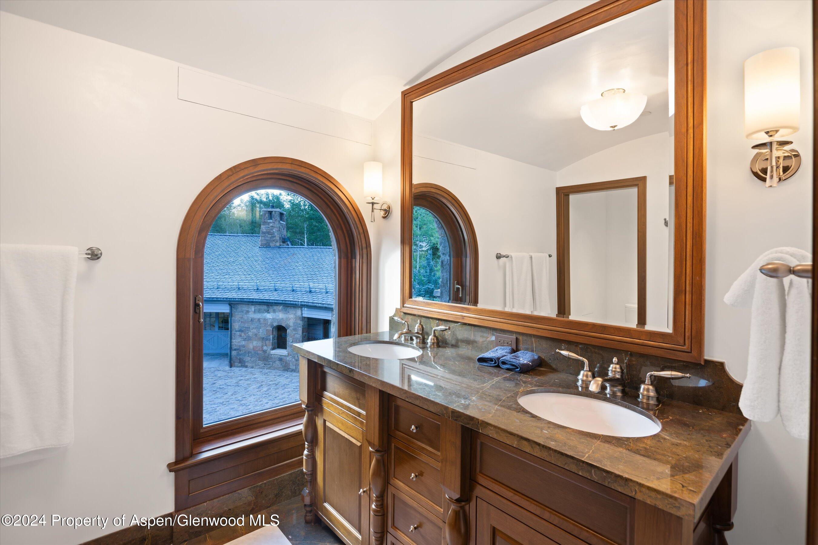 41 Popcorn Lane Aspen, CO 81611 - Photo 34 of 54 a en suite bathroom with a granite countertop sink and a mirror