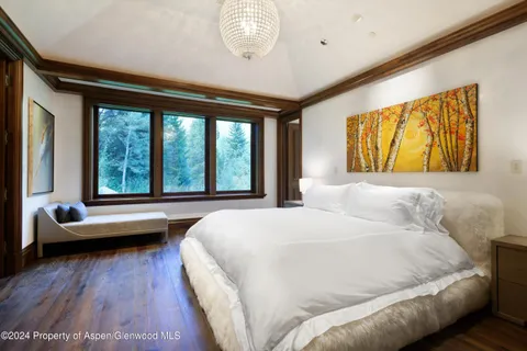 a bedroom with a large bed and a large window