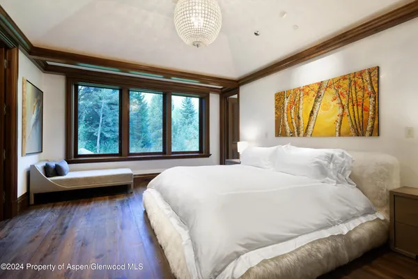 a bedroom with a large bed and a large window