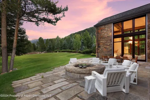 a view of a patio with furniture and garden