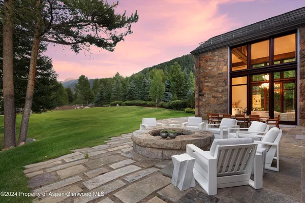 a view of a patio with furniture and garden