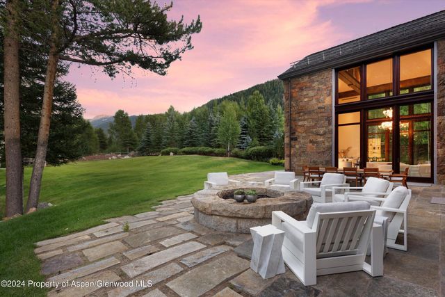 a view of a patio with furniture and garden