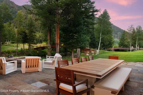an aerial view of a house with a yard and lake view