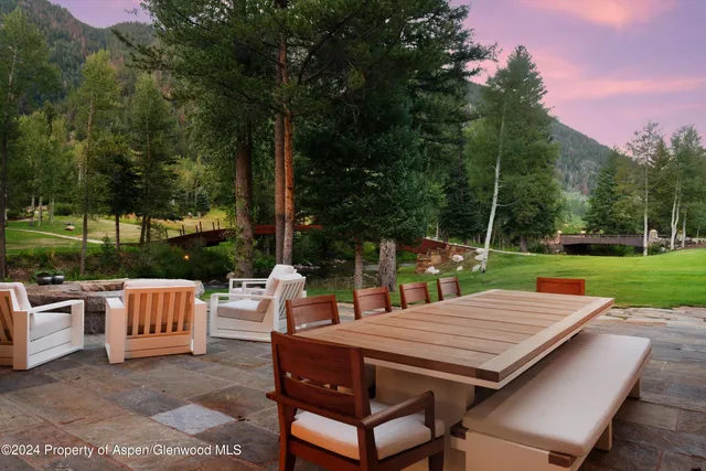 an aerial view of a house with a yard and lake view