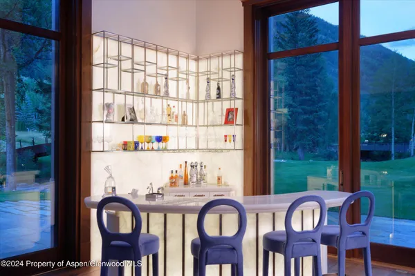 a front view of a dining room with furniture floor and garden view