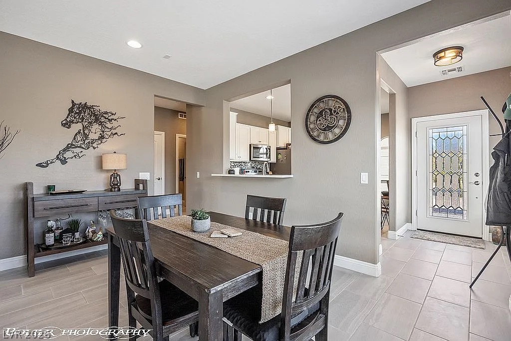 1304 Cottage Ridge Mesquite, NV 89034 - Photo 11 of 52 A graceful entry flows into the dining area, featuring a convenient pass-through window to the kitchen.