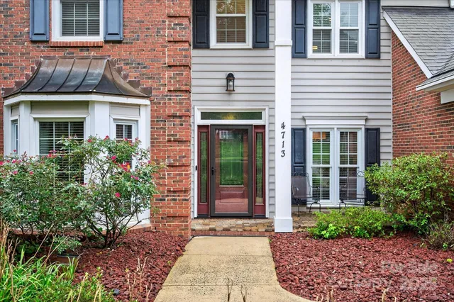 a view of a brick house with large windows