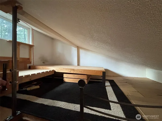 a view of a hallway with wooden floor and stairs