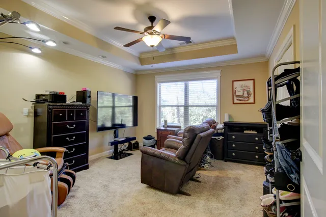 a living room with furniture gym equipment and a window