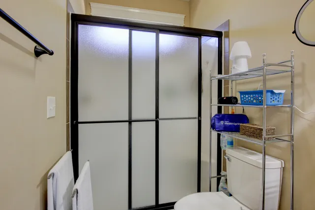 a bathroom with a shower a sink and a mirror