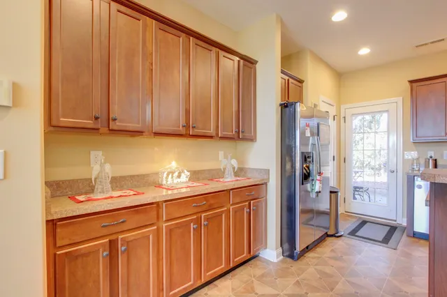 a kitchen with stainless steel appliances granite countertop a refrigerator and cabinets