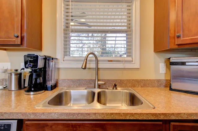 a kitchen with granite countertop a sink and a window