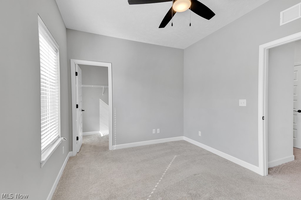 3601 Bailey Avenue Cleveland, OH 44113 - Photo 13 of 22 Carpeted empty room with ceiling fan and a healthy amount of sunlight