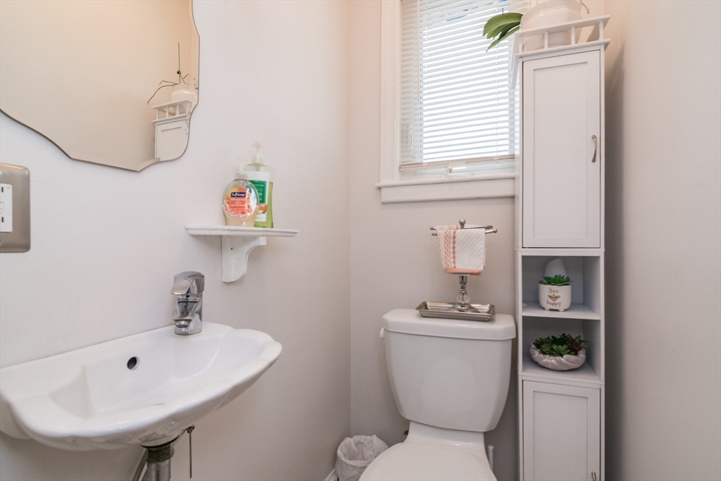 108 Brunswick Street Springfield, MA 01108 - Photo 14 of 42 a bathroom with a sink a toilet and a mirror