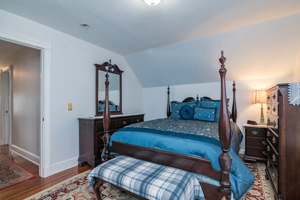 108 Brunswick Street Springfield, MA 01108 - Photo 18 of 42 a bedroom with a bed and wooden floor