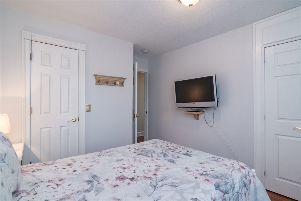 108 Brunswick Street Springfield, MA 01108 - Photo 23 of 42 a bedroom with a bed and a flat screen tv