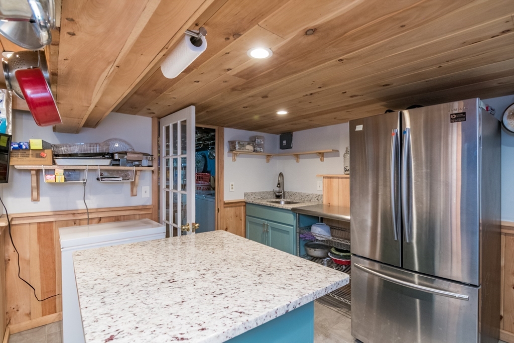 108 Brunswick Street Springfield, MA 01108 - Photo 28 of 42 a kitchen with stainless steel appliances kitchen island granite countertop a refrigerator stove and sink
