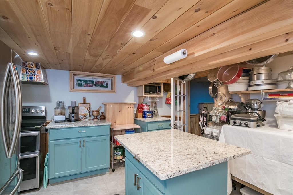 108 Brunswick Street Springfield, MA 01108 - Photo 29 of 42 a kitchen with a stove a refrigerator and a sink