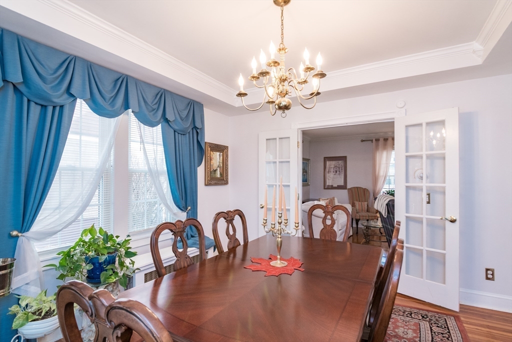 108 Brunswick Street Springfield, MA 01108 - Photo 7 of 42 a view of a dining room with furniture chandelier and wooden floor