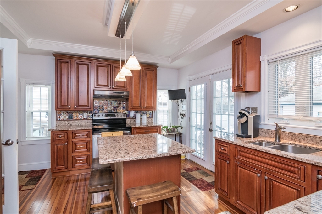 108 Brunswick Street Springfield, MA 01108 - Photo 8 of 42 a kitchen with stainless steel appliances granite countertop a sink stove and refrigerator