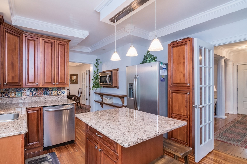108 Brunswick Street Springfield, MA 01108 - Photo 9 of 42 a kitchen with granite countertop a sink a counter space and stainless steel appliances