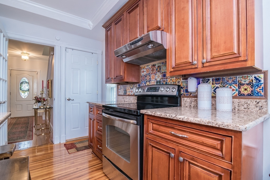 108 Brunswick Street Springfield, MA 01108 - Photo 10 of 42 a kitchen with stainless steel appliances granite countertop a sink stove and cabinets