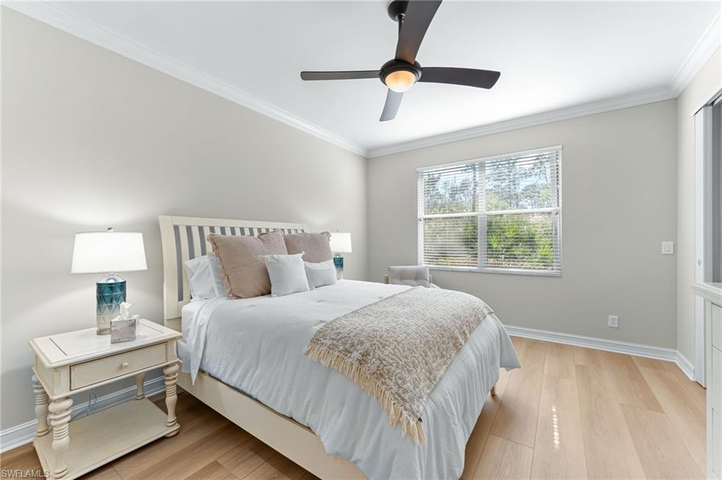 817 Carrick Bend Circle, Unit 102 Naples, FL 34110 - Photo 16 of 36 Bedroom featuring ornamental molding, light wood-style flooring, and ceiling fan