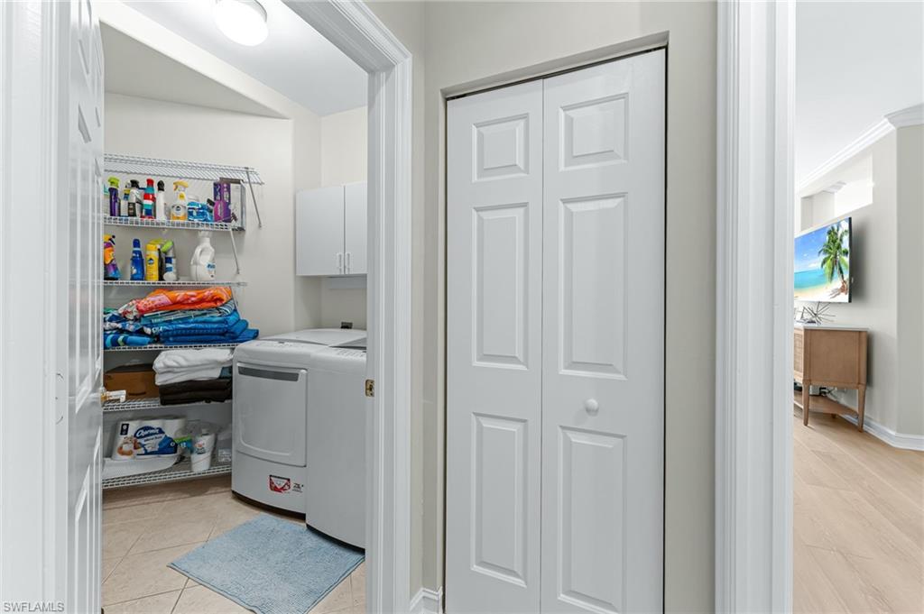 817 Carrick Bend Circle, Unit 102 Naples, FL 34110 - Photo 23 of 36 Laundry room featuring cabinet space and independent washer and dryer