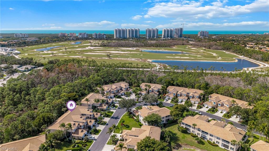 817 Carrick Bend Circle, Unit 102 Naples, FL 34110 - Photo 29 of 36 Aerial view of property and surrounding area featuring a nearby body of water and nearby suburban area