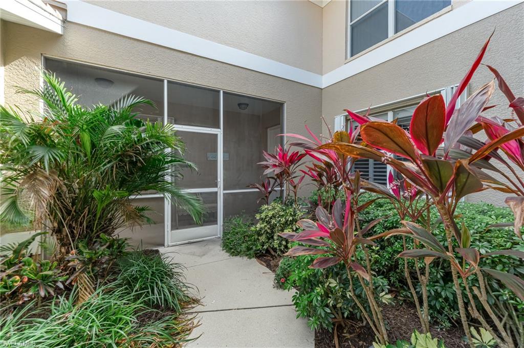 817 Carrick Bend Circle, Unit 102 Naples, FL 34110 - Photo 3 of 36 Entrance to property with a sunroom and stucco siding