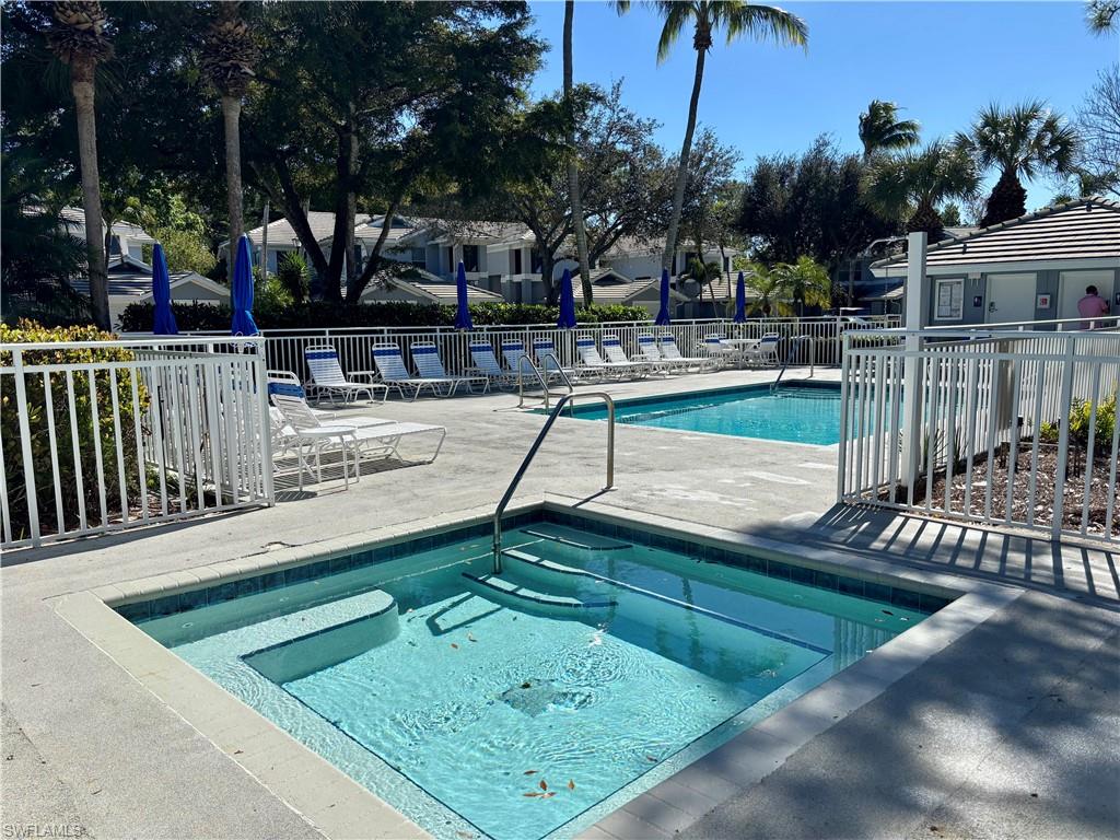 817 Carrick Bend Circle, Unit 102 Naples, FL 34110 - Photo 33 of 36 Community pool with a patio area and a community hot tub