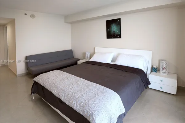 a bedroom with a bed and a couch