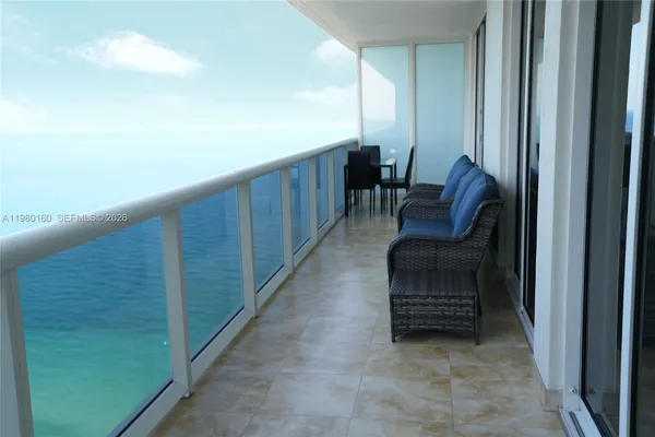 a view of balcony with furniture
