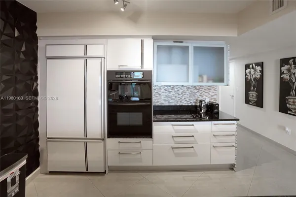 a kitchen with appliances and cabinets