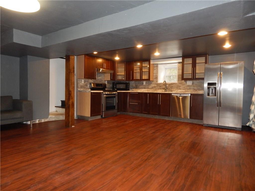 543 Oneida Valley Road Butler, PA 16001 - Photo 13 of 30 an open kitchen with wooden floor and stainless steel appliances