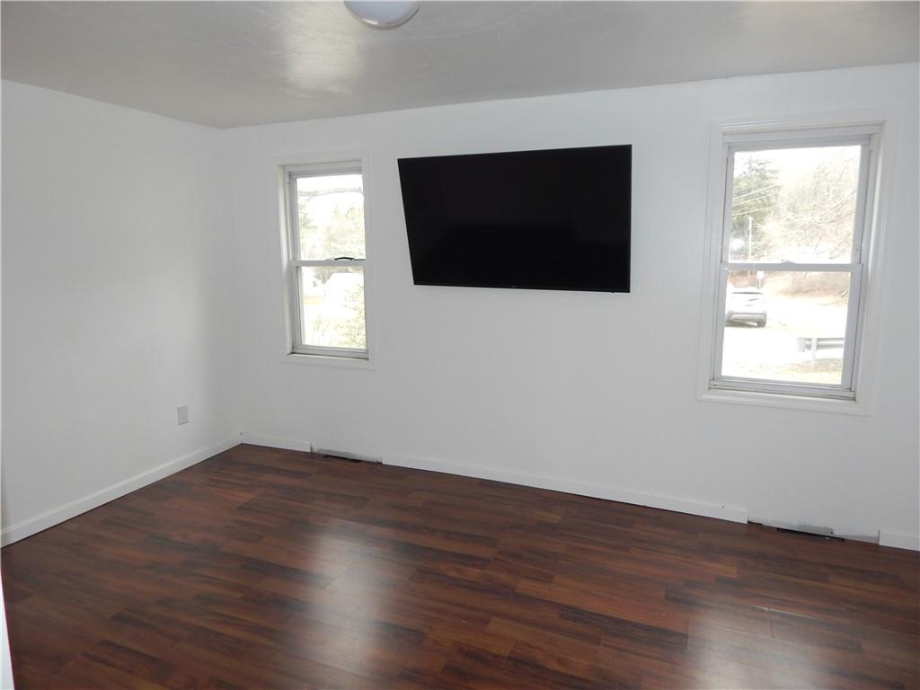 543 Oneida Valley Road Butler, PA 16001 - Photo 22 of 30 an empty room with wooden floor cabinet and windows