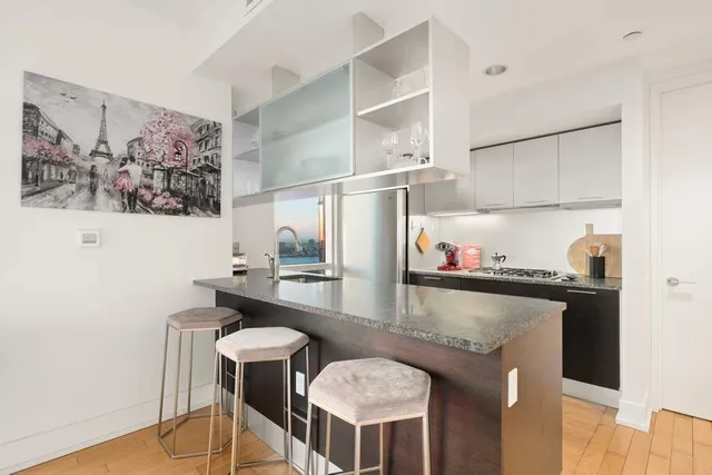 a kitchen with stainless steel appliances granite countertop a stove and a refrigerator