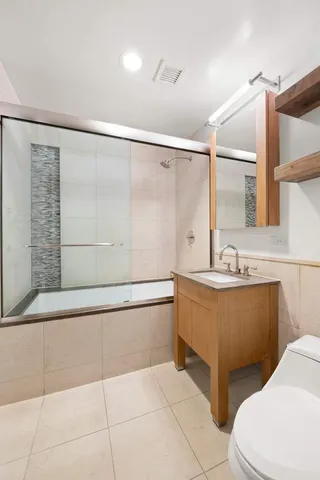 a bedroom with a bed and a view of living room