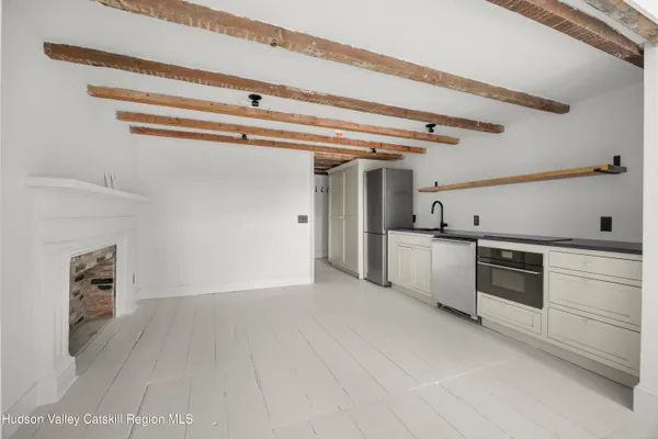 a view of a kitchen with a sink and dishwasher top oven