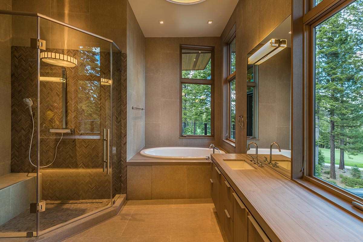8348 Valhalla Drive Truckee, CA 96161 - Photo 9 of 14 a bathroom with a granite countertop sink a large mirror and a bathtub