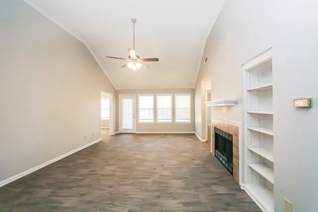 a view of empty room with a fireplace and window