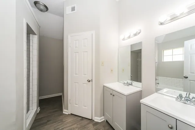 a bathroom with a double vanity sink and mirror