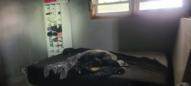 a bedroom with a bed and a window